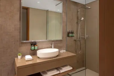 a bathroom with a sink and a shower at Staybridge Suites Dubai Business Bay by IHG in Dubai