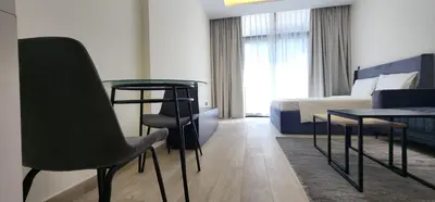 a hotel room with a bed and a table and chairs at Luxury Studio, 15m to Dubai Mall! in Dubai