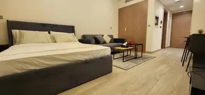 a bedroom with a large bed and a couch at Luxury Studio, 15m to Dubai Mall! in Dubai