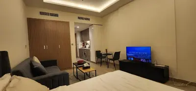 a living room with a couch and a flat screen tv at Luxury Studio, 15m to Dubai Mall! in Dubai
