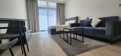 a living room with a couch and a table at Luxury Studio, 15m to Dubai Mall! in Dubai