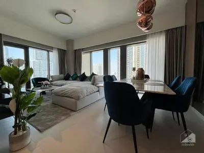 a living room with a couch and a table and chairs at Dreamy Getaway 4B in Burj Royale Downtown in Dubai
