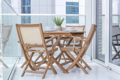 a wooden dining room table with two chairs at Business Bay Bliss 1 bedroom apartment - Suiteable in Dubai