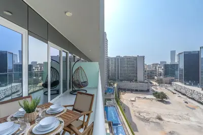 a balcony with a table and chairs and a view of a city at Business Bay Bliss 1 bedroom apartment - Suiteable in Dubai