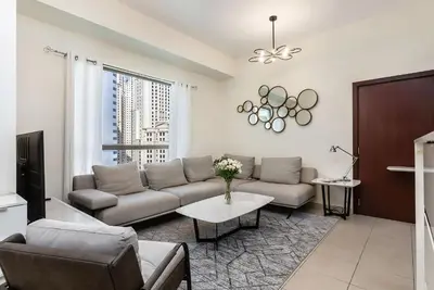 a living room with a couch and a table at Excellent 1BR Apertments at Bahar 6 in Dubai