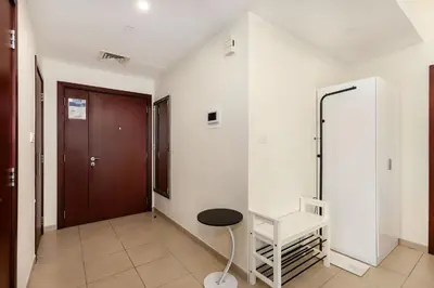 a hallway with a chair and a door at Excellent 1BR Apertments at Bahar 6 in Dubai