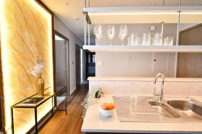 a kitchen with a sink and a counter with dishes at Burj Roayle-Magical Burj & Fountain Sky Views 3+1 BR APT in Dubai