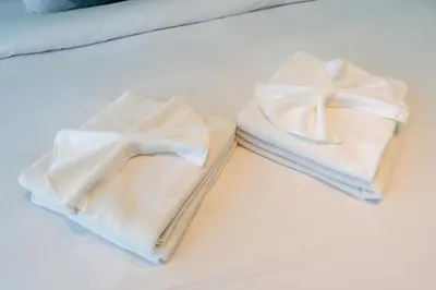 two towels sitting on top of a table at One Bedroom - 10min from Burj Khalifa - Lagoon View in Dubai