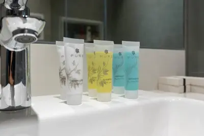 a group of four cups sitting on top of a counter at One Bedroom - 10min from Burj Khalifa - Lagoon View in Dubai
