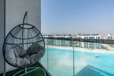 a bird cage sitting on top of a building with a pool at One Bedroom - 10min from Burj Khalifa - Lagoon View in Dubai