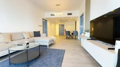 a living room with a couch and a table at Jumeriah Lake Tower (JLT)-(LAKE VIEW) in Dubai