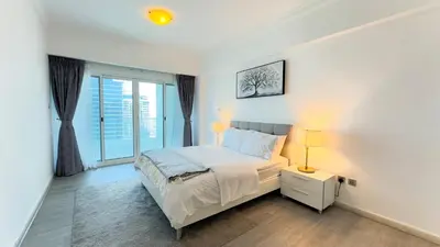 a white bedroom with a bed and a window at Jumeriah Lake Tower (JLT)-(LAKE VIEW) in Dubai