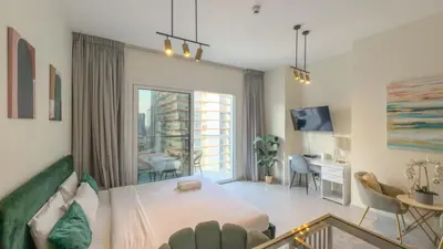 a bedroom with a bed and a desk in a room at Ahlan HH - Charming Studio at AG Tower in Dubai