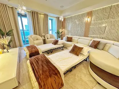 a living room with two beds and a couch at Life Above Clouds in Dubai