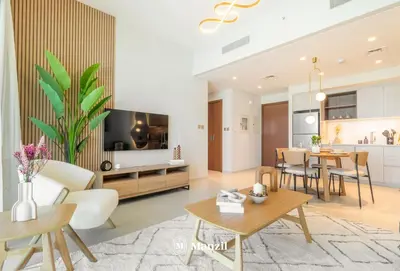 a living room with a kitchen and a dining room at Manzil - Sleek 1BR Home in Dubai Creek with Beach & Marina Access in Dubai