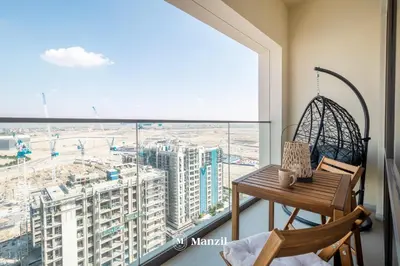 a table and chair in a room with a large window at Manzil - Sleek 1BR Home in Dubai Creek with Beach & Marina Access in Dubai