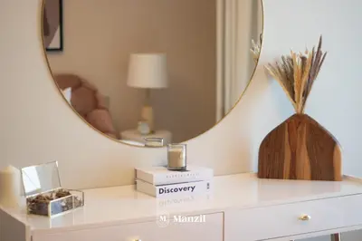 a dressing room with a mirror and a white dresser at Manzil - Sleek 1BR Home in Dubai Creek with Beach & Marina Access in Dubai