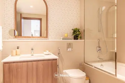 a bathroom with a sink and a shower and a toilet at Manzil - Sleek 1BR Home in Dubai Creek with Beach & Marina Access in Dubai