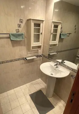 a bathroom with a sink and a mirror at Marina view with Pool, Gym, Tennis Court, 5 mins to Beach in Dubai