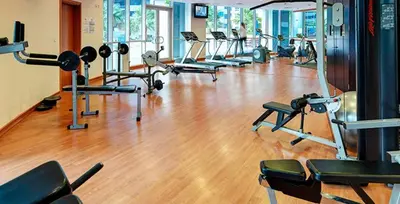 a gym with a bunch of treadms and machines at Marina view with Pool, Gym, Tennis Court, 5 mins to Beach in Dubai