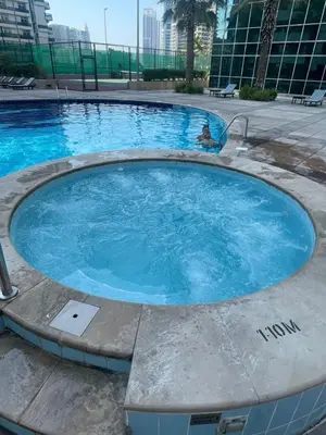 a large pool of water with a dog in it at Marina view with Pool, Gym, Tennis Court, 5 mins to Beach in Dubai