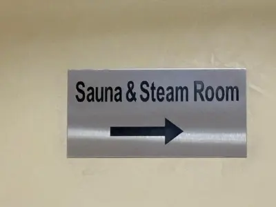 a sign with an arrow pointing toenna and steam room at Marina view with Pool, Gym, Tennis Court, 5 mins to Beach in Dubai
