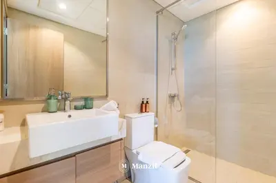a bathroom with a toilet and a sink and a shower at Azizi Farhad in Dubai