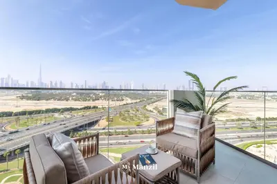 a balcony with chairs and a view of the city at Azizi Farhad in Dubai