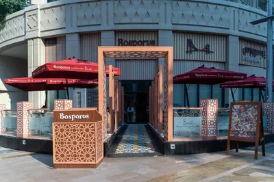 an entrance to a building with umbrellas in front at BellaVista - Graceful - 1 BR - 29 Boulevard - with Burj Khalifa View in Dubai