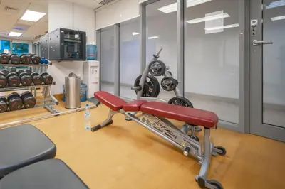 a gym with a red bench in a room at BellaVista - Graceful - 1 BR - 29 Boulevard - with Burj Khalifa View in Dubai