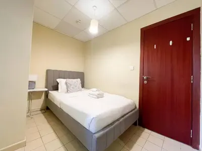 a bedroom with a large bed with a red door at Spacious 4BR Apartment in JBR next to the Beach in Dubai
