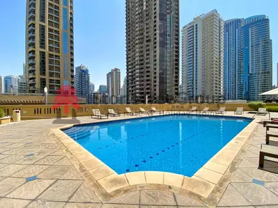 a swimming pool in a city with tall buildings at Spacious 4BR Apartment in JBR next to the Beach in Dubai