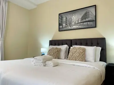 a bedroom with a large bed with two towels on it at Spacious 4BR Apartment in JBR next to the Beach in Dubai