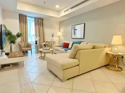a living room with a couch and a table at Your Cosy Dubai Marina Home in Dubai