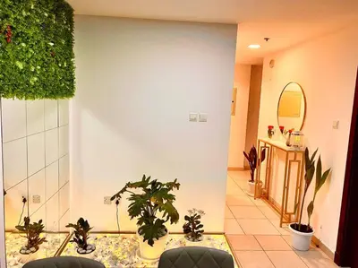 a hallway with potted plants in a room at Your Cosy Dubai Marina Home in Dubai