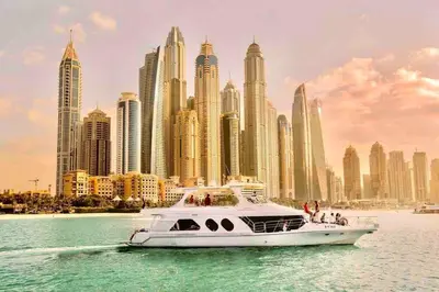 a white boat in the water in front of a city at Your Cosy Dubai Marina Home in Dubai