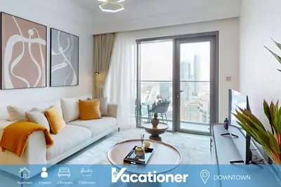 a living room with a couch and a large window at Vacationer I Elegant 2 Bed with City Views I Walk to Dubai Mall & Burj Khalifa I Downtown I Burj Royale Tower in Dubai