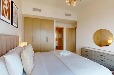 a bedroom with a white bed and a mirror at Vacationer I Elegant 2 Bed with City Views I Walk to Dubai Mall & Burj Khalifa I Downtown I Burj Royale Tower in Dubai