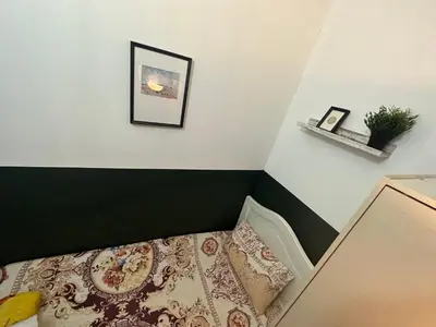a bedroom with a bed and a picture on the wall at Private Partition Room Near Mashreq Metro in Dubai
