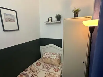 a small bedroom with a bed with a pillow at Private Partition Room Near Mashreq Metro in Dubai