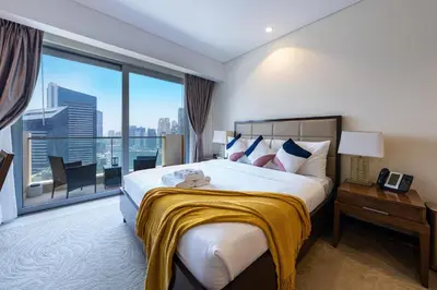 a bedroom with a large bed and a large window at Luxury Address Res Dubai Marina Studio in Dubai