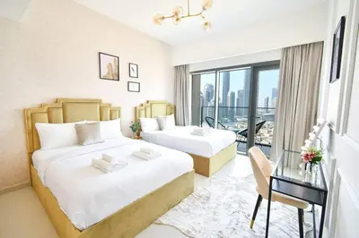 a hotel room with two beds and a balcony at cinematic&Chic Burj Khalifa &Fountain View 2BR APT in Dubai
