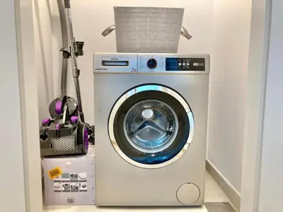 a washing machine with a basket on top of it at Luxurious 1-bedroom With Skyline View In Downtown Views Ii in Dubai