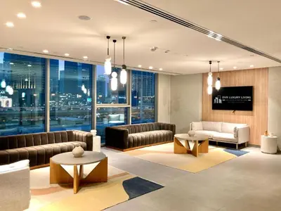a living room with leather furniture and a large window at Luxurious 1-bedroom With Skyline View In Downtown Views Ii in Dubai