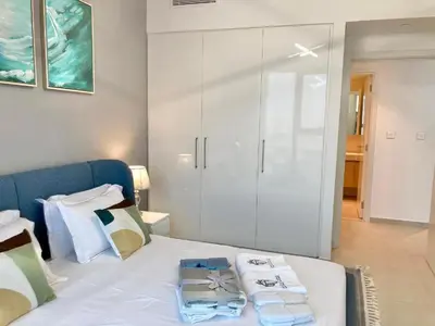 a bedroom with a bed with two towels on it at Luxurious 1-bedroom With Skyline View In Downtown Views Ii in Dubai