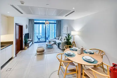 a dining room and living room with a table and chairs at Amazing 1 BD in Marina Gate 2 Dubai Marina in Dubai