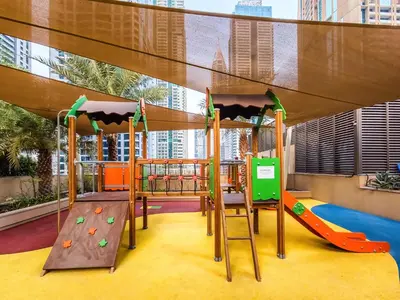 a playground in a building with a slide and swings at Amazing 1 BD in Marina Gate 2 Dubai Marina in Dubai
