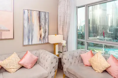 a living room with two couches and a large window at Elite Royal Apartment - Full Burj Khalifa & Fountain View - 2 Bedrooms + 1 Open Bedroom Without Partition - Magnate in Dubai
