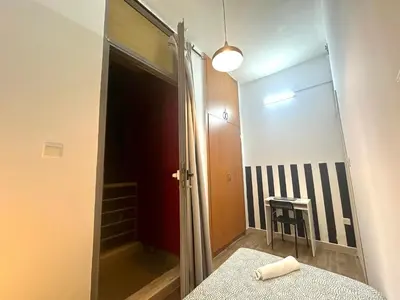 a bathroom with a mirror and a bed in a room at Cityview Partition Room with Balcony in Tecom in Dubai
