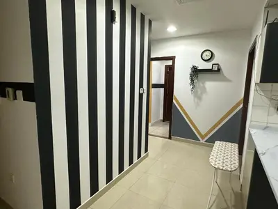 a hallway with a black and white striped wall at Partition Room 3 Mins to Mashreq Metro in Dubai